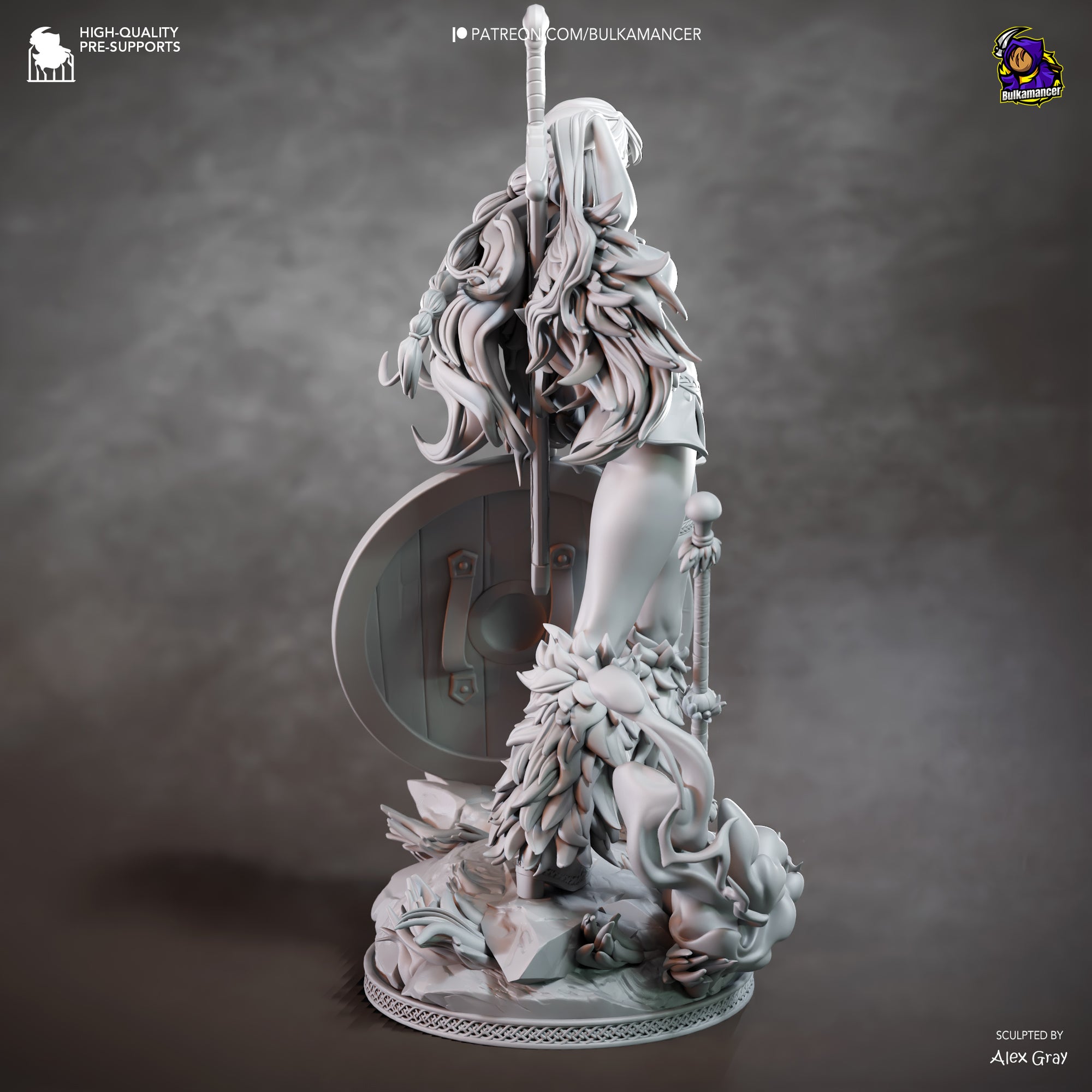 The image is a detailed sculpture of a female figure with long hair and a shield, standing on a base with a lot of intricate details.