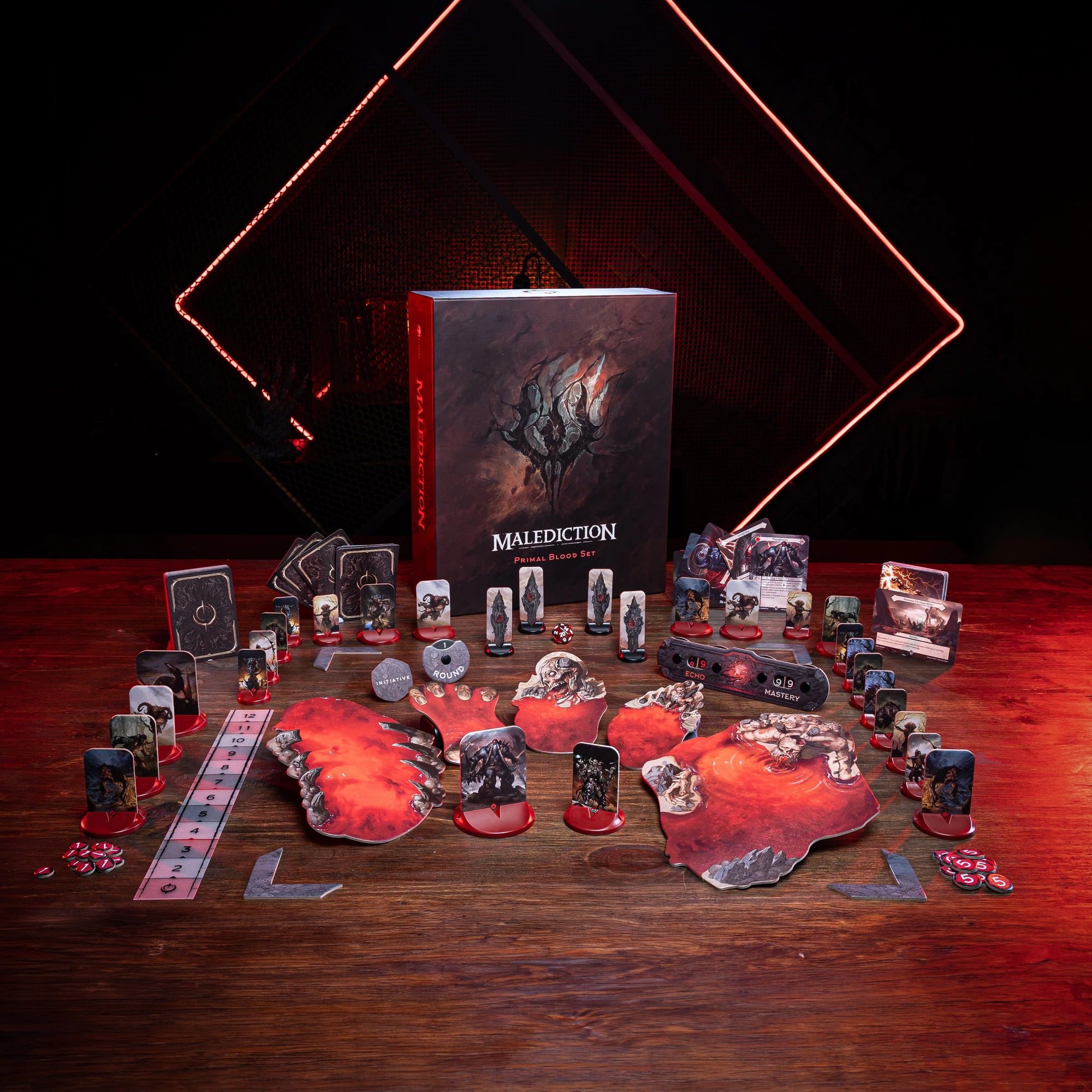 a collection of board game components, including a box, various cards, and other game pieces, arranged on a wooden surface. The background features a dark, dramatic lighting that creates a moody atmosphere.