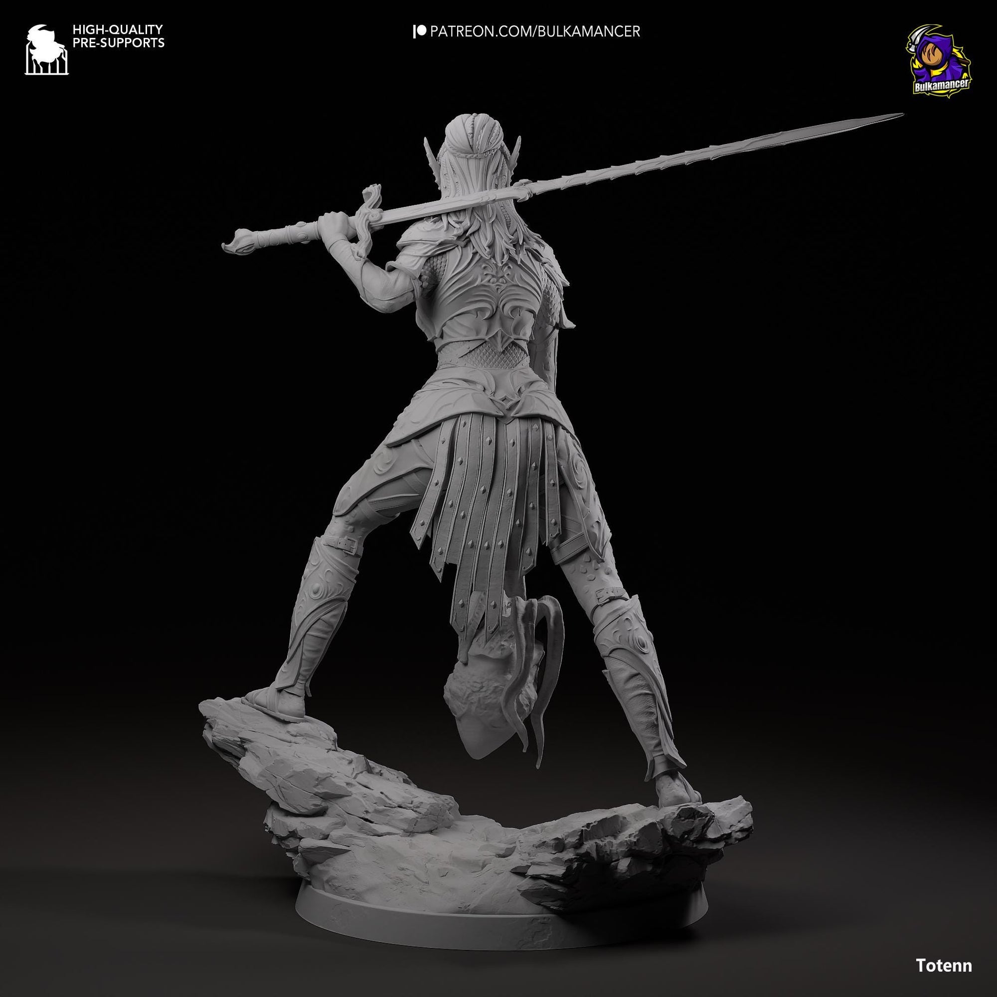 a statue of a man with a sword on a rock