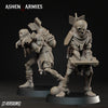 two figurines of soldiers, one standing and one kneeling, with various weapons and equipment attached to them.