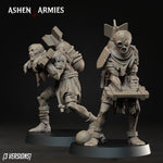 two figurines of soldiers, one standing and one kneeling, with various weapons and equipment attached to them.