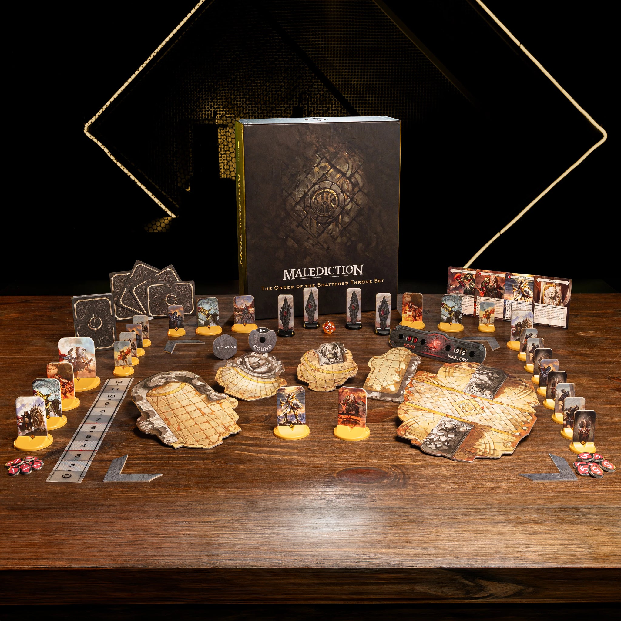 a board game called "Malicious Order" with various game components and accessories arranged on a wooden table.